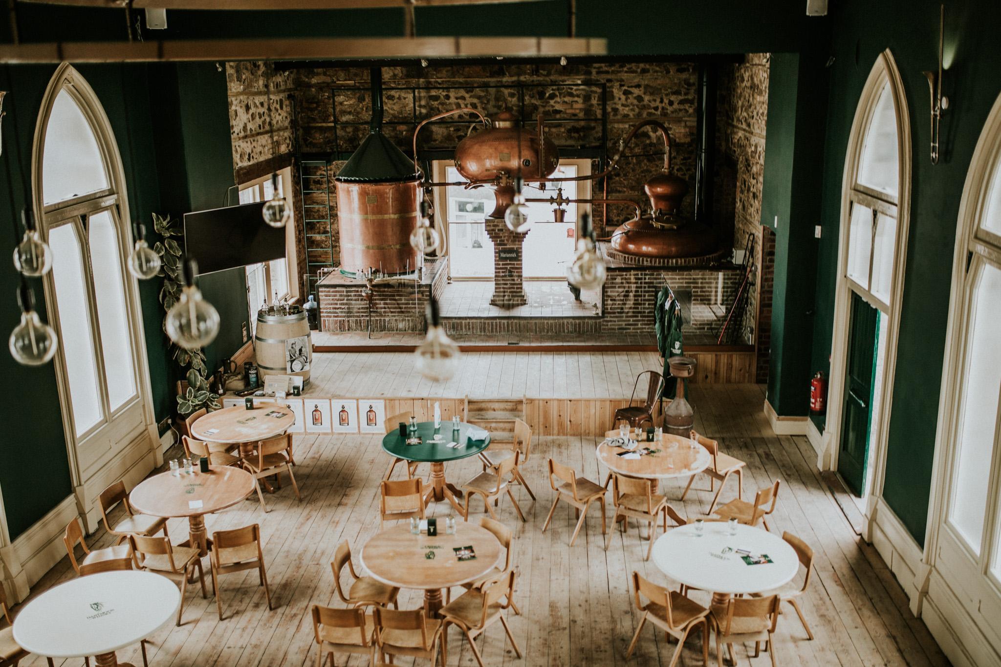 Dartmoor Whisky Distillery is based inside a historic building with communal seating in a rustic setting.